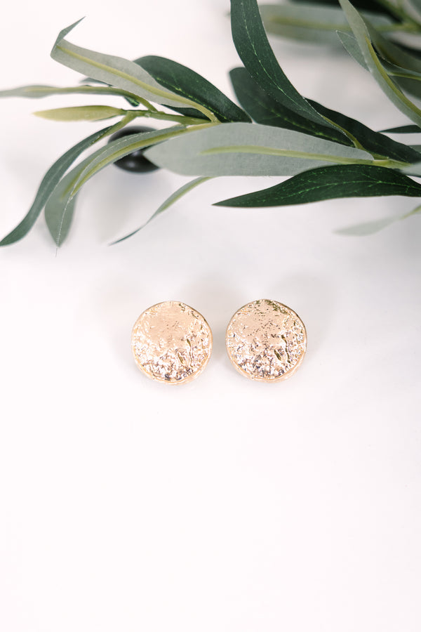 Textured gold round stud earrings with a hammered metallic finish.