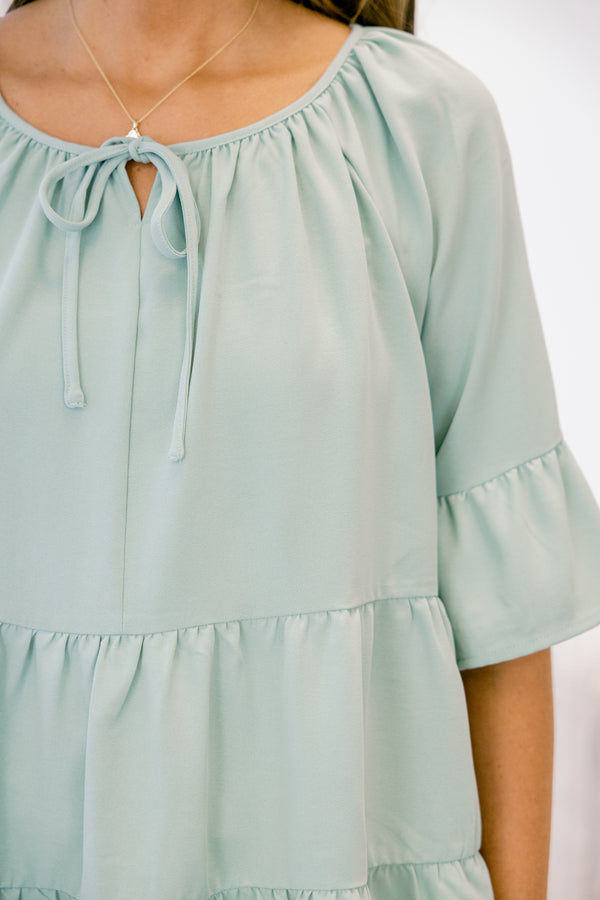 Chic Soul plus size clothing, short-sleeve ruffled dusty sage green baby doll top with a subtle v-neckline and tie on the neckline