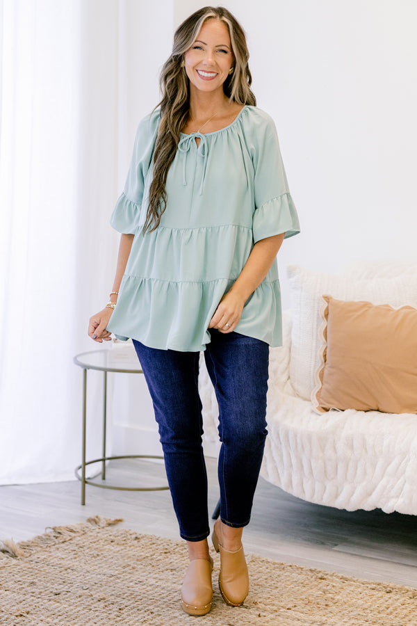 Chic Soul plus size clothing, short-sleeve ruffled dusty sage green baby doll top with a subtle v-neckline and tie on the neckline