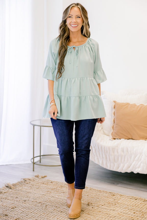 Chic Soul plus size clothing, short-sleeve ruffled dusty sage green baby doll top with a subtle v-neckline and tie on the neckline
