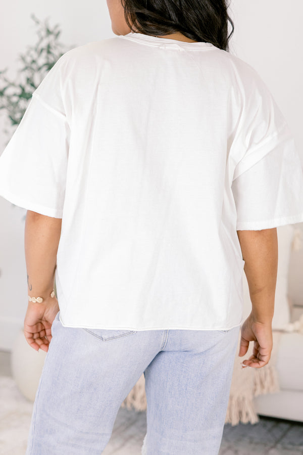 Chic Soul plus size clothing, white short sleeve graphic tee with a checkered pink and green smiley face on the center of the shirt 