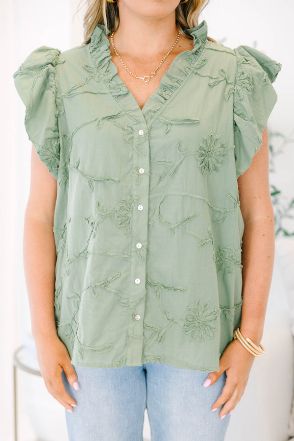 Plus Size olive green textured floral top with ruffle cap sleeves and a button-down front.