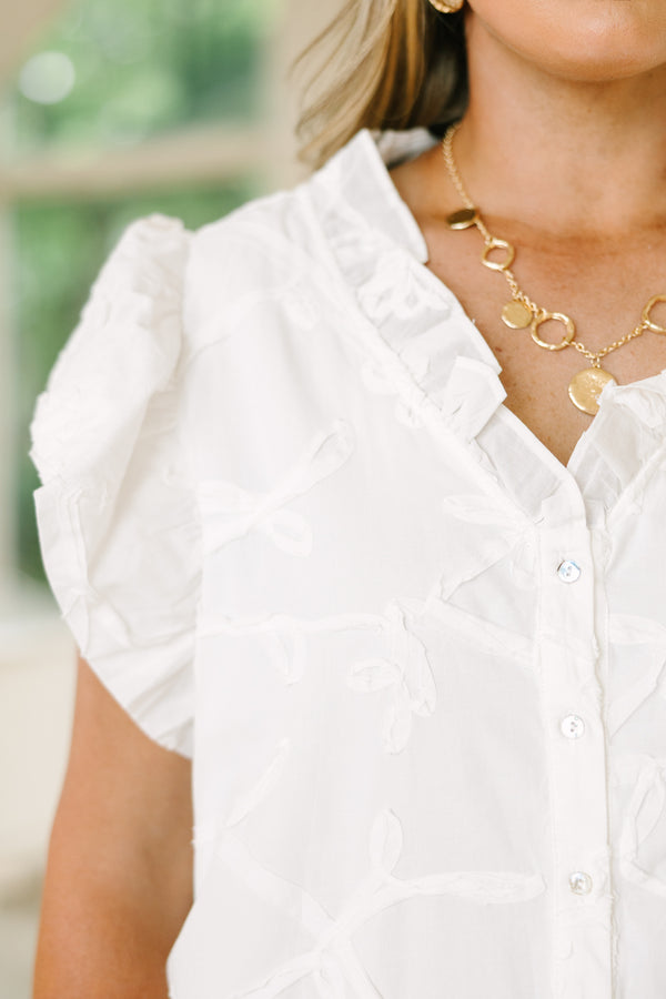 Plus Size white floral jacquard top with ruffle v-neckline and flutter sleeves.