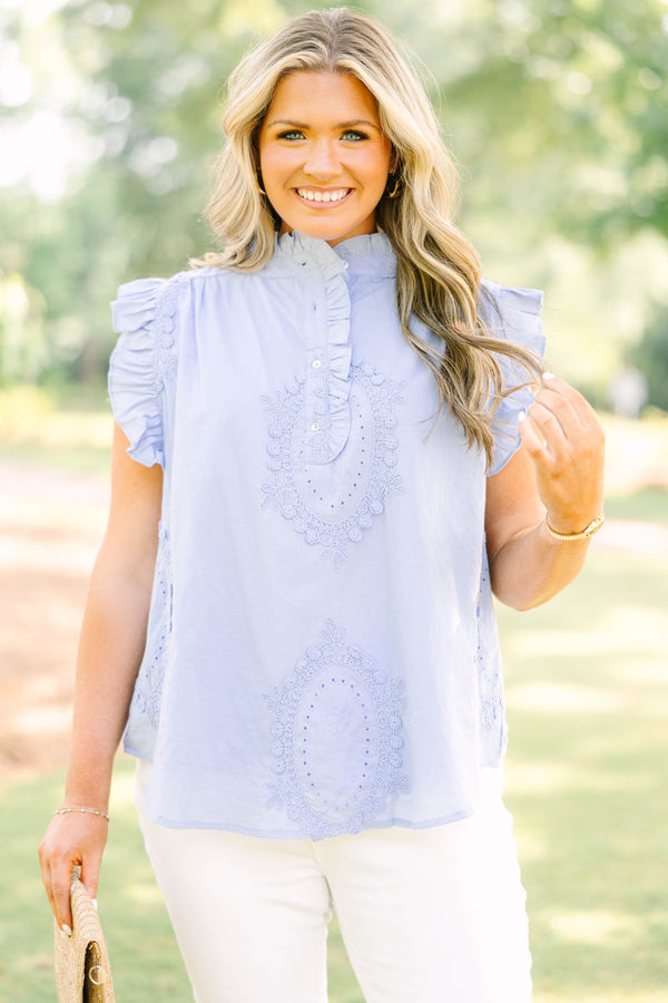 Plus Size light blue sleeveless top with ruffle trim, high neck, and intricate floral embroidery.