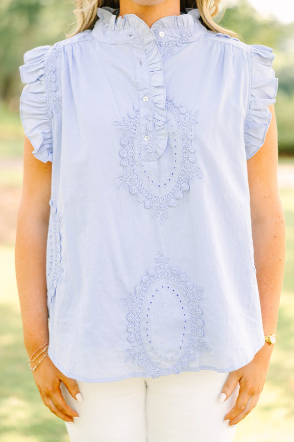 Plus Size light blue sleeveless top with ruffle trim, high neck, and intricate floral embroidery.