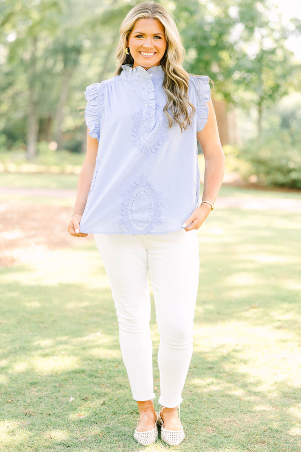 Plus Size light blue sleeveless top with ruffle trim, high neck, and intricate floral embroidery.