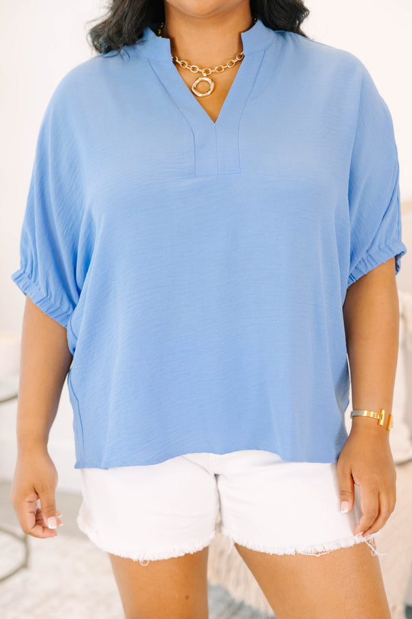 Plus Size chambray blue short-sleeve top with a notched V-neckline and white denim shorts.