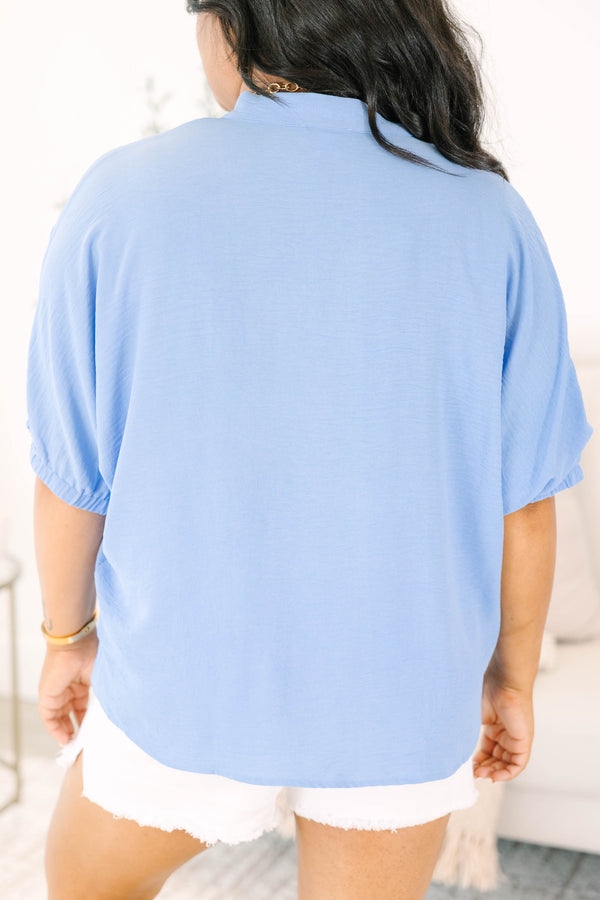 Plus Size chambray blue short-sleeve top with a notched V-neckline and white denim shorts.