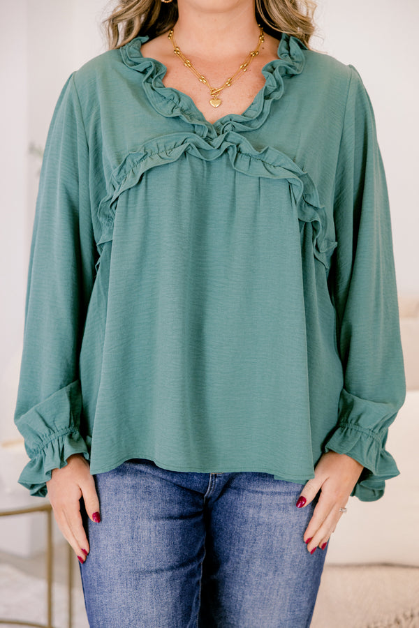 Chic Soul plus size clothing, dark green long sleeve top with ruffles on the end of the sleeves and outlining the chest