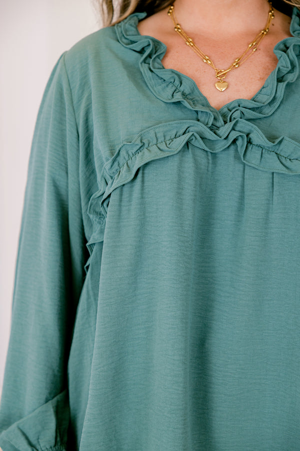 Chic Soul plus size clothing, dark green long sleeve top with ruffles on the end of the sleeves and outlining the chest