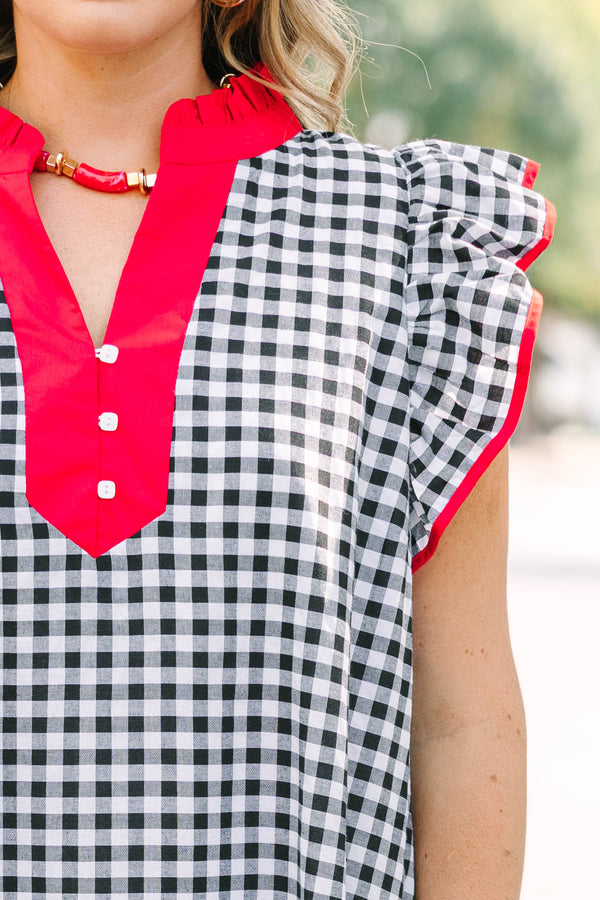 Plus Size black and white gingham maxi dress with red ruffled v-neckline and flutter sleeves.