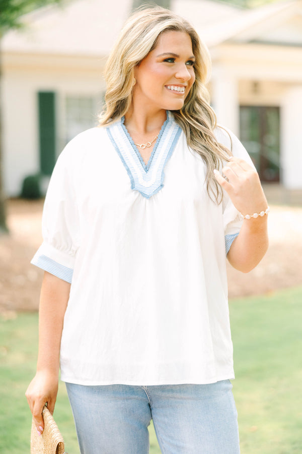 Plus Size white v-neck blouse with blue striped contrast trim, jacquard detail, and puff sleeves.