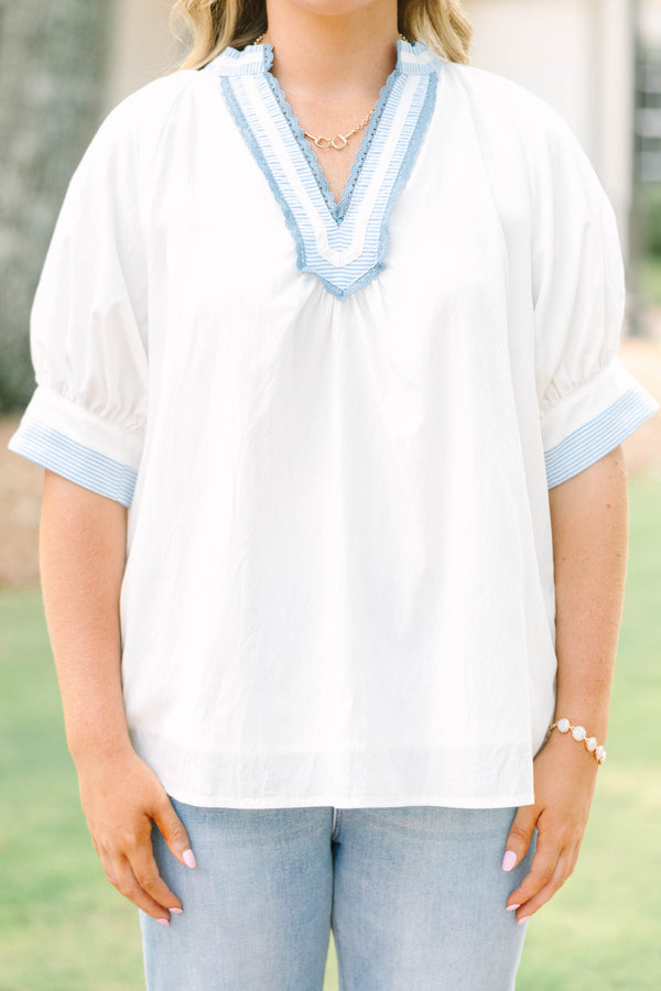 Plus Size white v-neck blouse with blue striped contrast trim, jacquard detail, and puff sleeves.