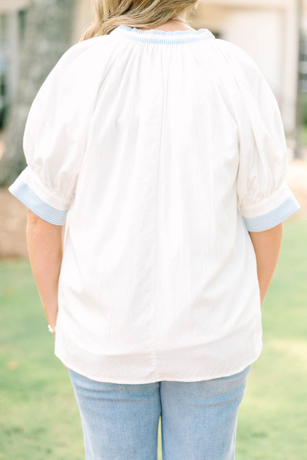 Plus Size white v-neck blouse with blue striped contrast trim, jacquard detail, and puff sleeves.