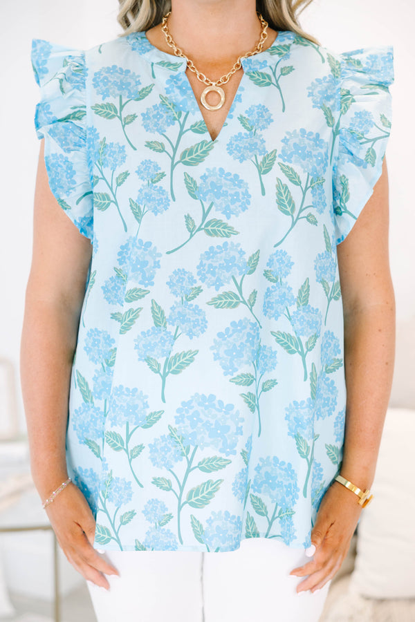 Plus Size light blue top with a floral hydrangea print, ruffle cap sleeves, and a split neckline.
