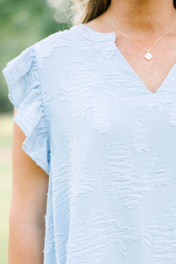Plus Size baby blue textured top with a V-neckline and ruffled short sleeves.