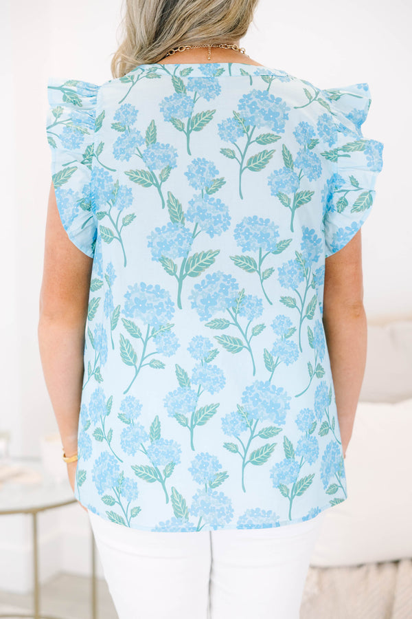 Plus Size light blue top with a floral hydrangea print, ruffle cap sleeves, and a split neckline.