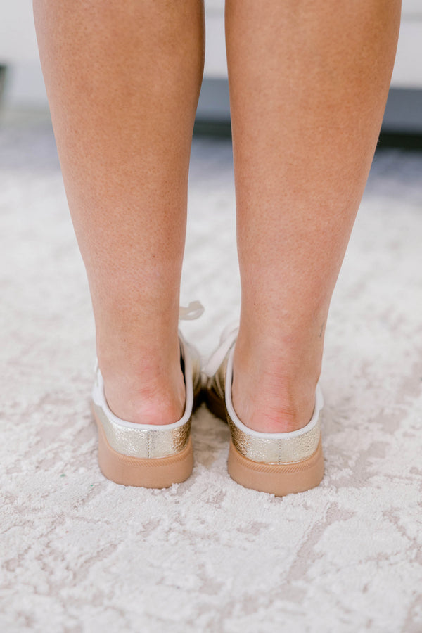 Chic Soul plus size clothing, gold sneakers with a taupe platform and a white stripe detail on one side of each sneaker 