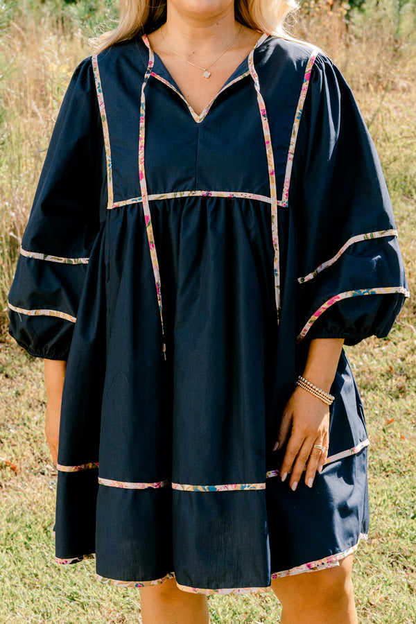 Chic Soul plus size clothing, navy long puff sleeve knee length dress with floral patterned detailing on the seams and tassels at the neckline