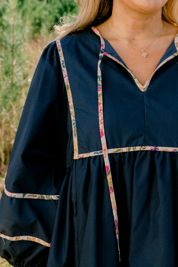 Chic Soul plus size clothing, navy long puff sleeve knee length dress with floral patterned detailing on the seams and tassels at the neckline