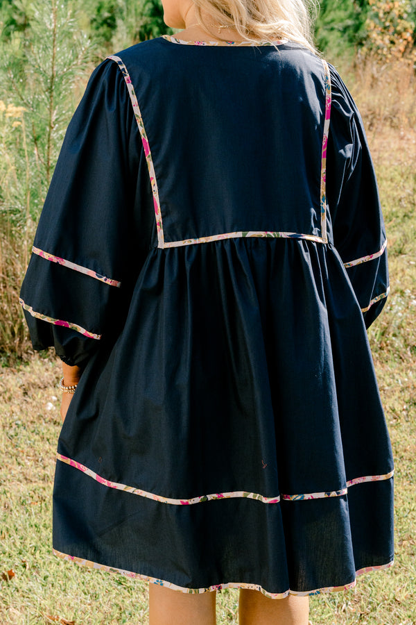 Chic Soul plus size clothing, navy long puff sleeve knee length dress with floral patterned detailing on the seams and tassels at the neckline