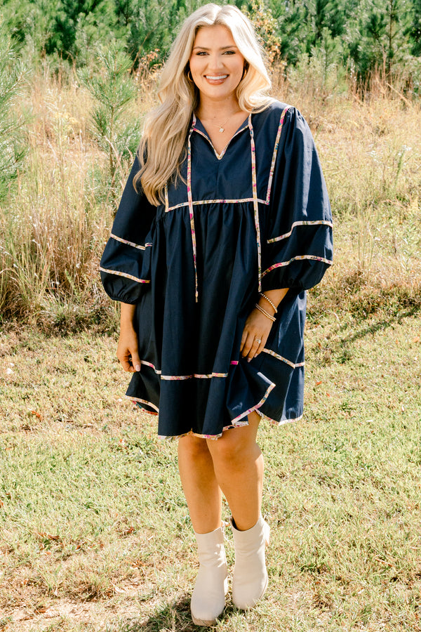 Chic Soul plus size clothing, navy long puff sleeve knee length dress with floral patterned detailing on the seams and tassels at the neckline