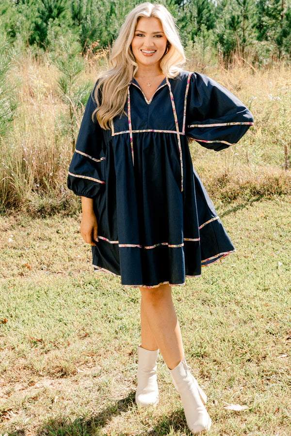 Chic Soul plus size clothing, navy long puff sleeve knee length dress with floral patterned detailing on the seams and tassels at the neckline