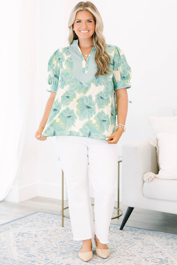 Plus size green floral print top with puff sleeves and a V-neckline.