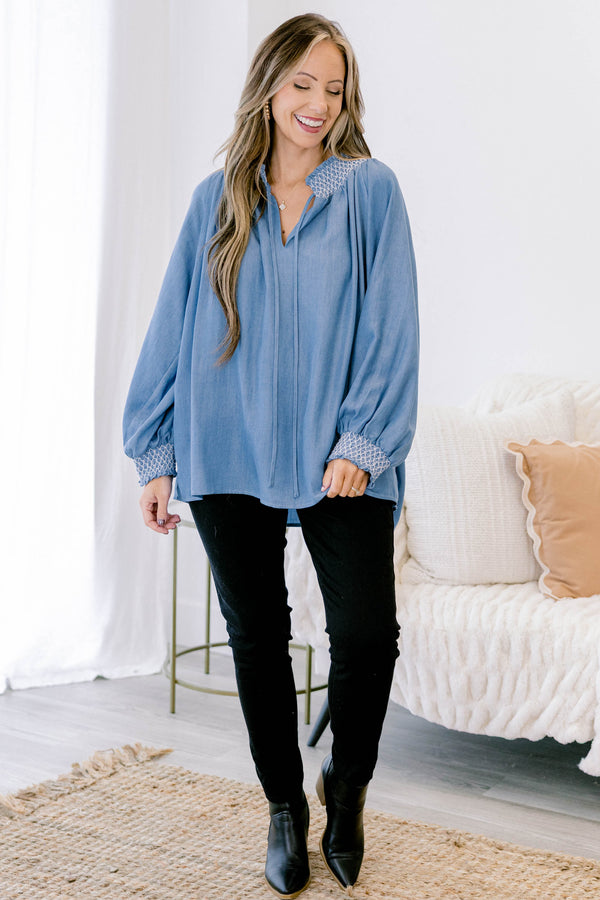 Chic soul plus size clothing, long sleeve flowy denim blouse with white stitching detailing around the collar and cuff of the sleeves, with 2 drawstrings at the collar