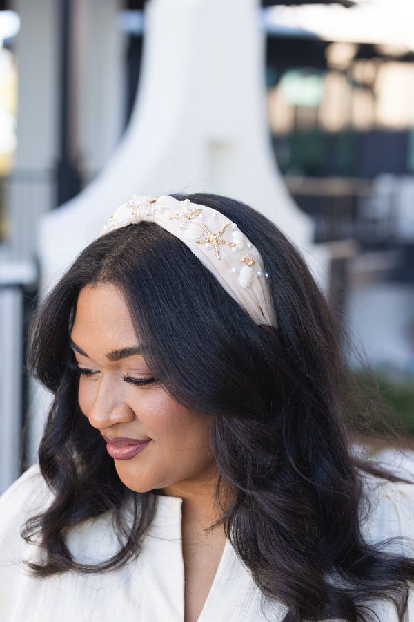 Chic Soul plus size clothing, cream and tan burlap style headband with knot in the middle and gold starfish, beige shells, and pearls sown into the headband
