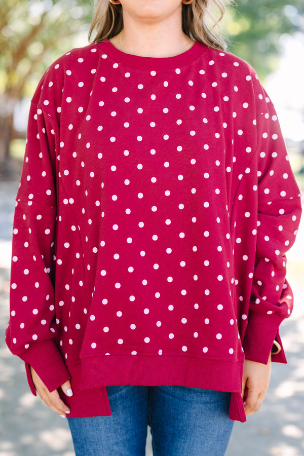 Plus size Sunset Glow Pullover in burgundy with white polka dots, featuring a relaxed, flowy fit.