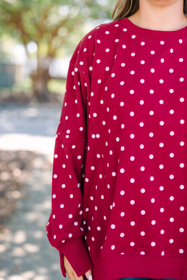 Plus size Sunset Glow Pullover in burgundy with white polka dots, featuring a relaxed, flowy fit.