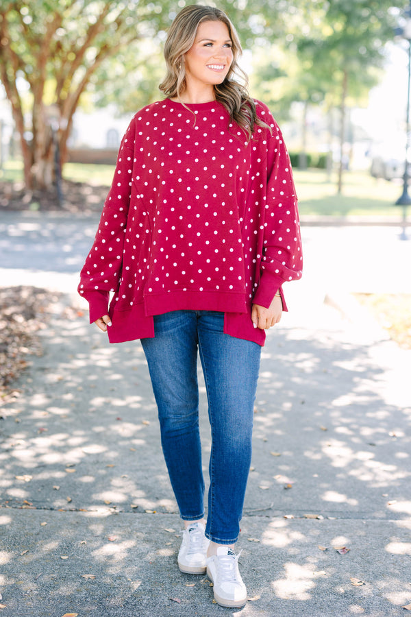 Plus size Sunset Glow Pullover in burgundy with white polka dots, featuring a relaxed, flowy fit.