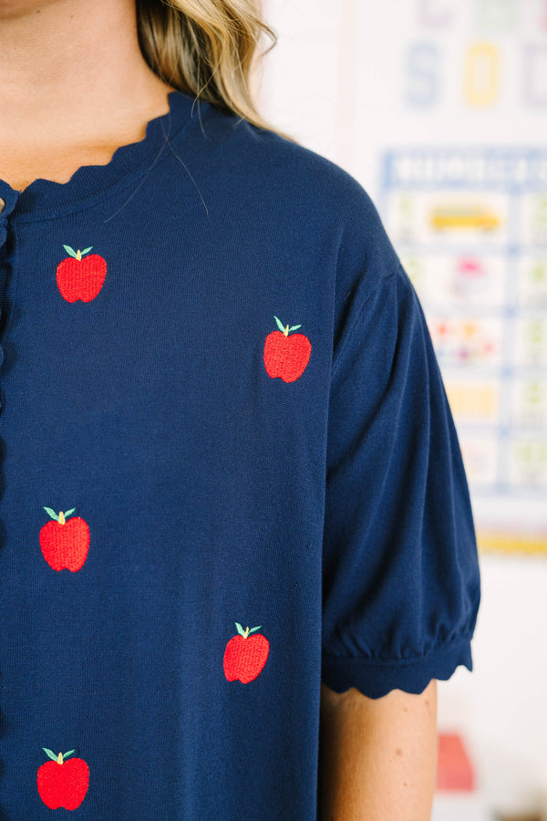 Plus size navy short sleeve cardigan with red embroidered apples, scallop trim, and a button-down front.