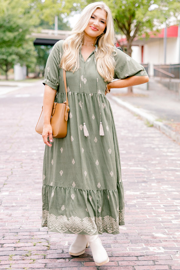 Chic Soul plus size clothing, green maxi dress with short sleeves that have a cuff at the end of each sleeve as well as a block pattern throughout and tassels hanging from the neckline 