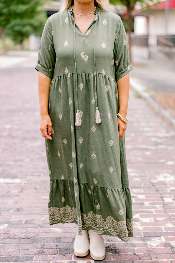 Chic Soul plus size clothing, green maxi dress with short sleeves that have a cuff at the end of each sleeve as well as a block pattern throughout and tassels hanging from the neckline 