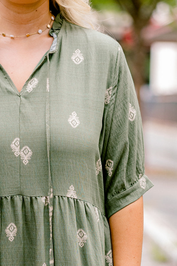 Chic Soul plus size clothing, green maxi dress with short sleeves that have a cuff at the end of each sleeve as well as a block pattern throughout and tassels hanging from the neckline 