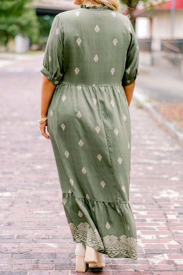 Chic Soul plus size clothing, green maxi dress with short sleeves that have a cuff at the end of each sleeve as well as a block pattern throughout and tassels hanging from the neckline 