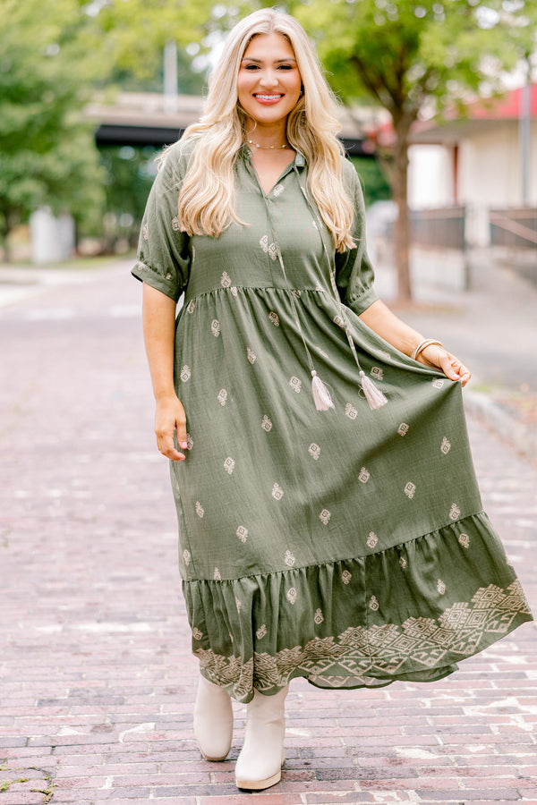 Chic Soul plus size clothing, green maxi dress with short sleeves that have a cuff at the end of each sleeve as well as a block pattern throughout and tassels hanging from the neckline 
