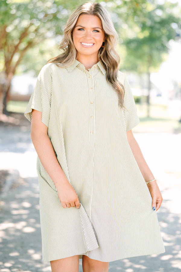 Plus size woman in a green stripe Sweet Breeze shirt dress with a flowy fit and button-down front.