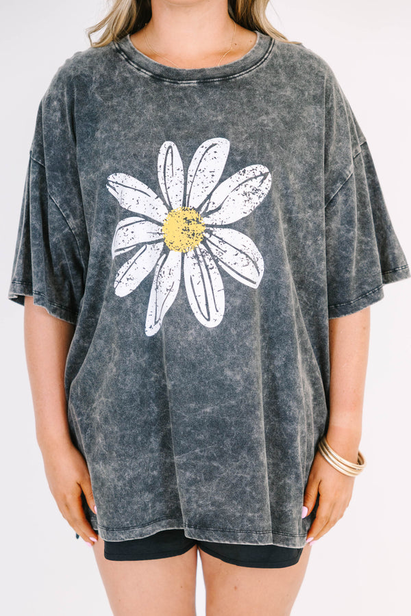 Plus Size black acid wash relaxed tee with a large white and yellow daisy graphic on the front.