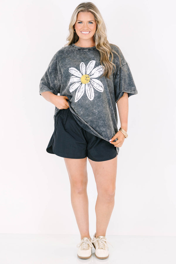 Plus Size black acid wash relaxed tee with a large white and yellow daisy graphic on the front.