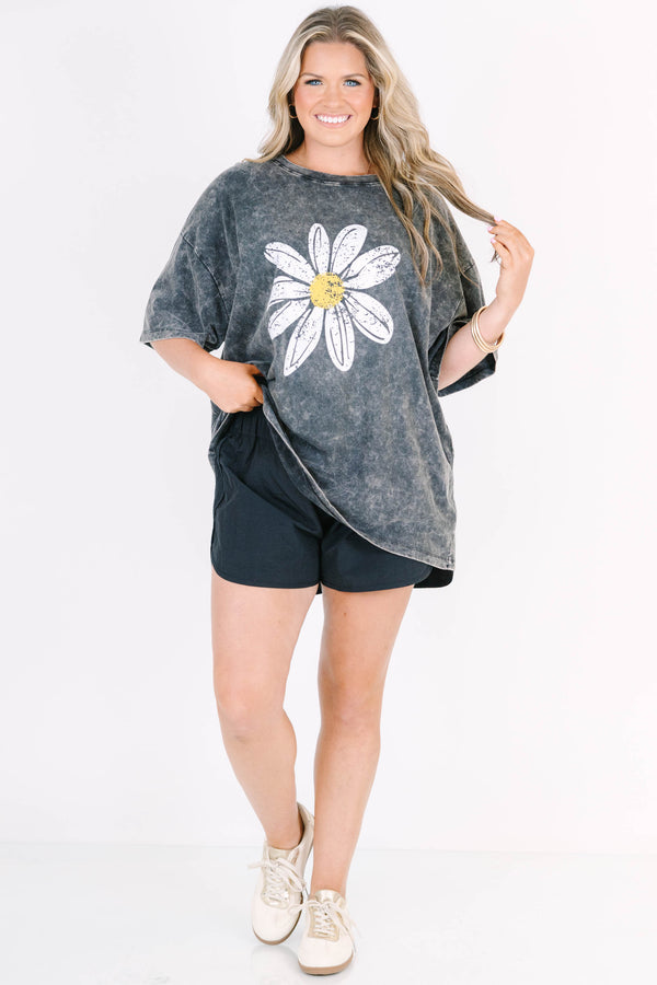 Plus Size black acid wash relaxed tee with a large white and yellow daisy graphic on the front.