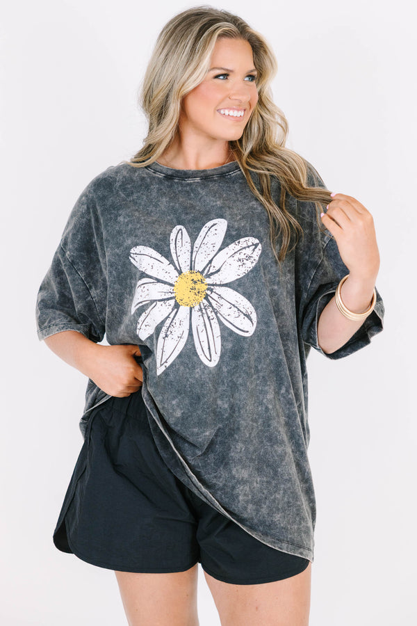 Plus Size black acid wash relaxed tee with a large white and yellow daisy graphic on the front.