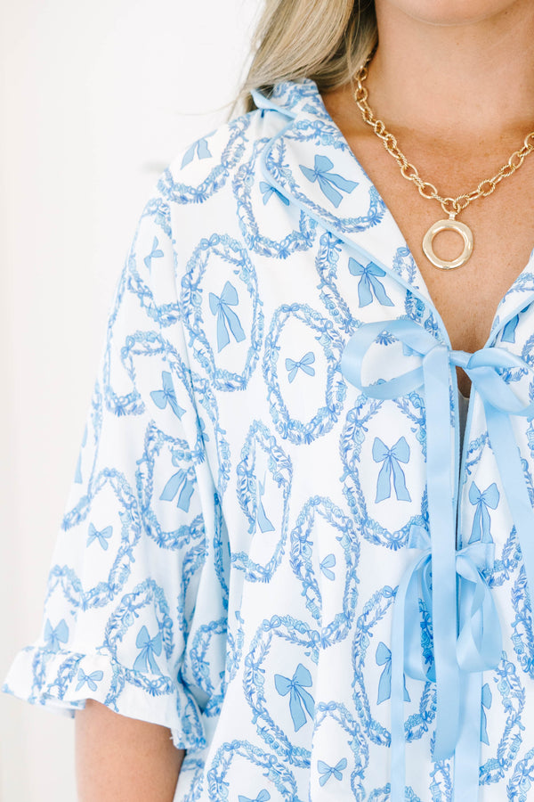 Plus Size blue and white bow print pajama set with a tie-front top and matching ruffled shorts.