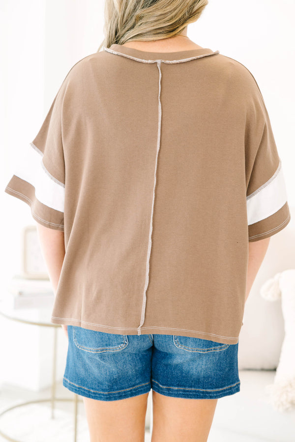 Plus size woman in a mocha and white striped oversized tee with raw edge details
