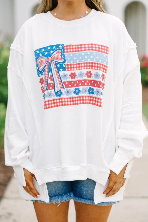 Plus Size ivory crew neck sweatshirt with a patriotic floral flag graphic and denim shorts.