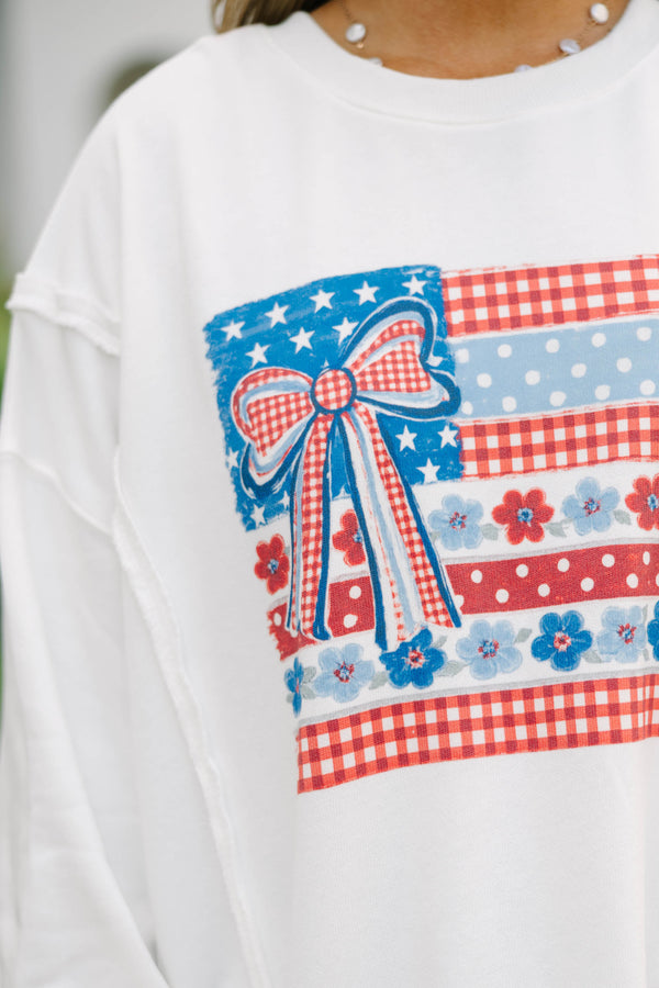 Plus Size ivory crew neck sweatshirt with a patriotic floral flag graphic and denim shorts.