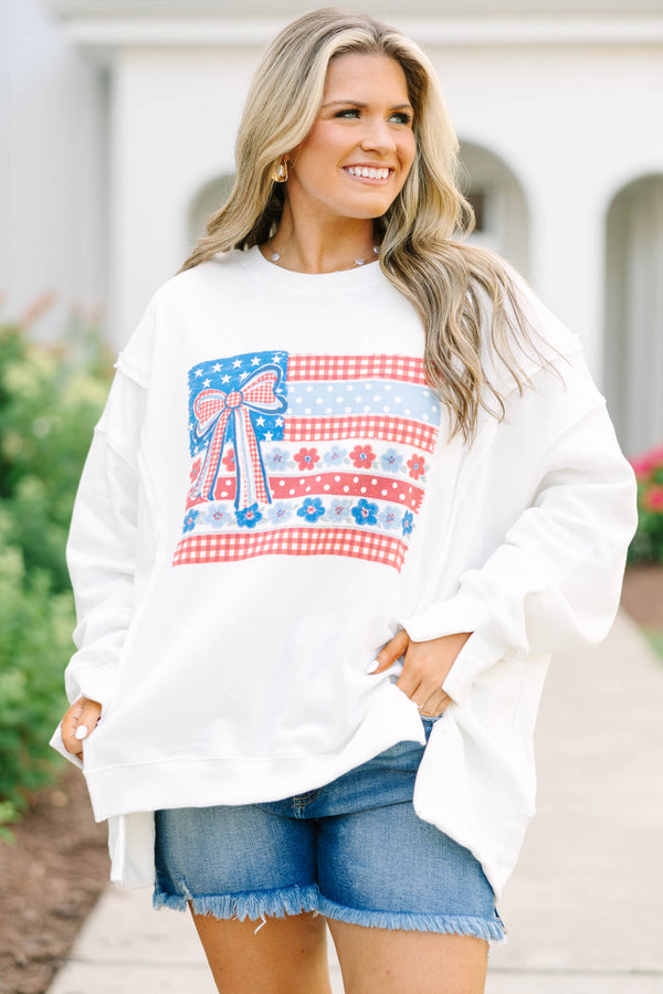 Plus Size ivory crew neck sweatshirt with a patriotic floral flag graphic and denim shorts.