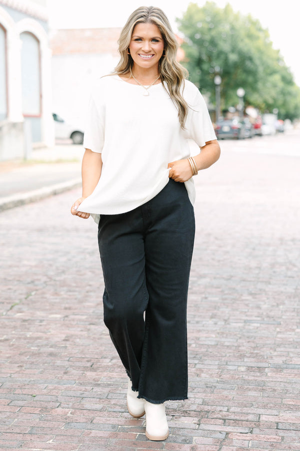 Plus Size black acid-washed wide-leg jeans with a frayed cutoff hem and a straight fit.